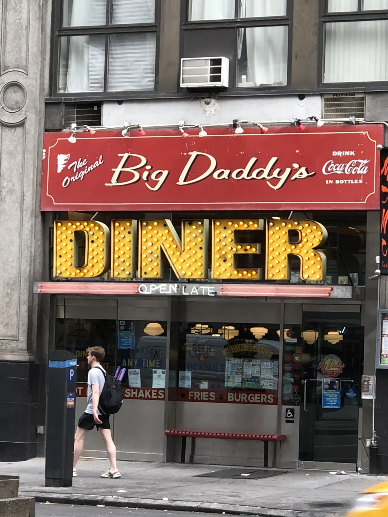 Red Big Daddy’s script sign above yellow bulb-lit DINER letters and an OPEN LATE neon strip